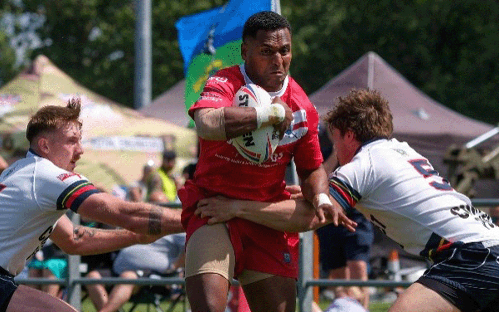 Action shot of players in a rugby match.