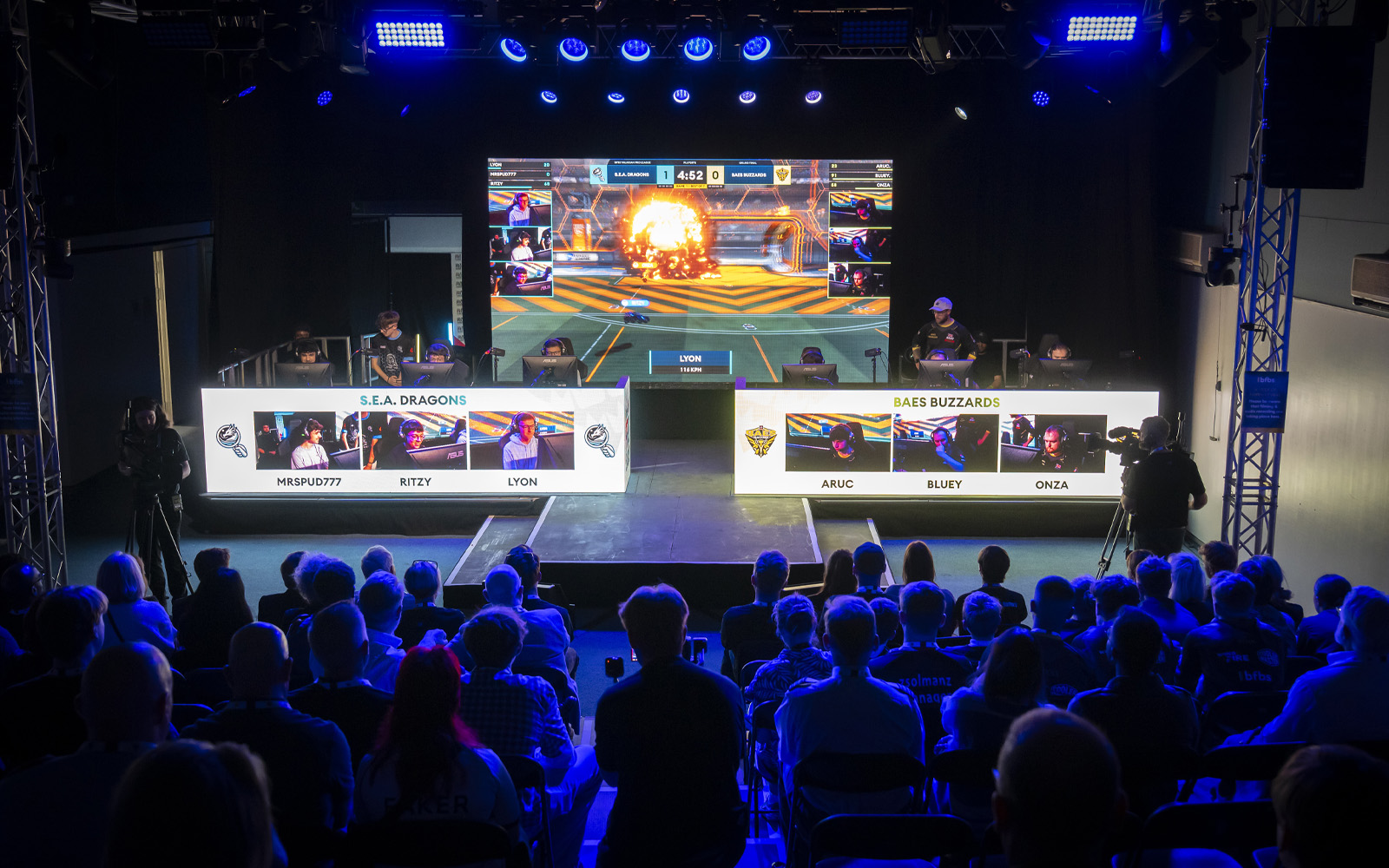 Wide shot from the Royal Air Force Museum London with a crowd watching competitors take part in the BFBS Pro League Grand Final.