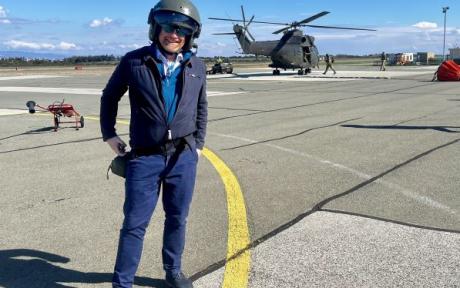 Ben Chapman wearing a helicopter helmet standing on an airfield