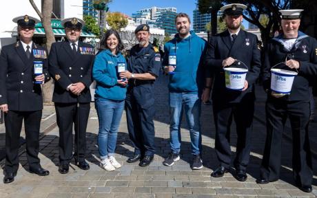 Team BFBS and armed forces volunteers on the streets of Gibraltar posing with BFBS Bug Salute collection buckets.