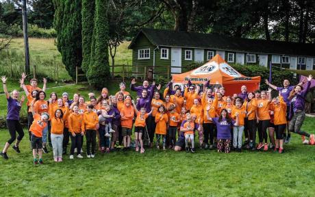 Group of people at an adventure event cheering and celebrating.