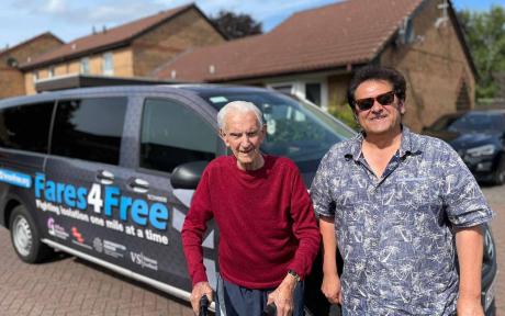 Two people stood in front of a taxi car, veteran.