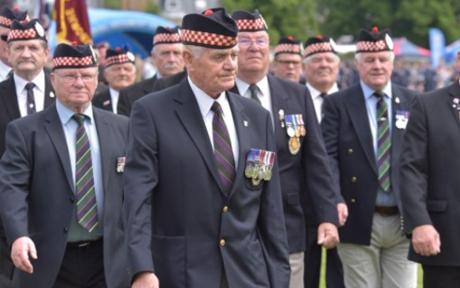 Group of veterans walking together at a memorial event.