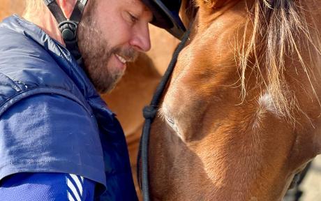 Close up of a person next to a horse.