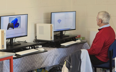 Close up of someone working at a computer workstation.