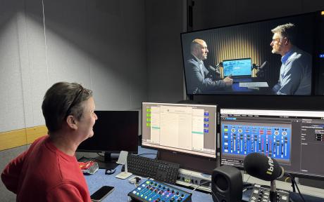 Video production studio with producer and screens